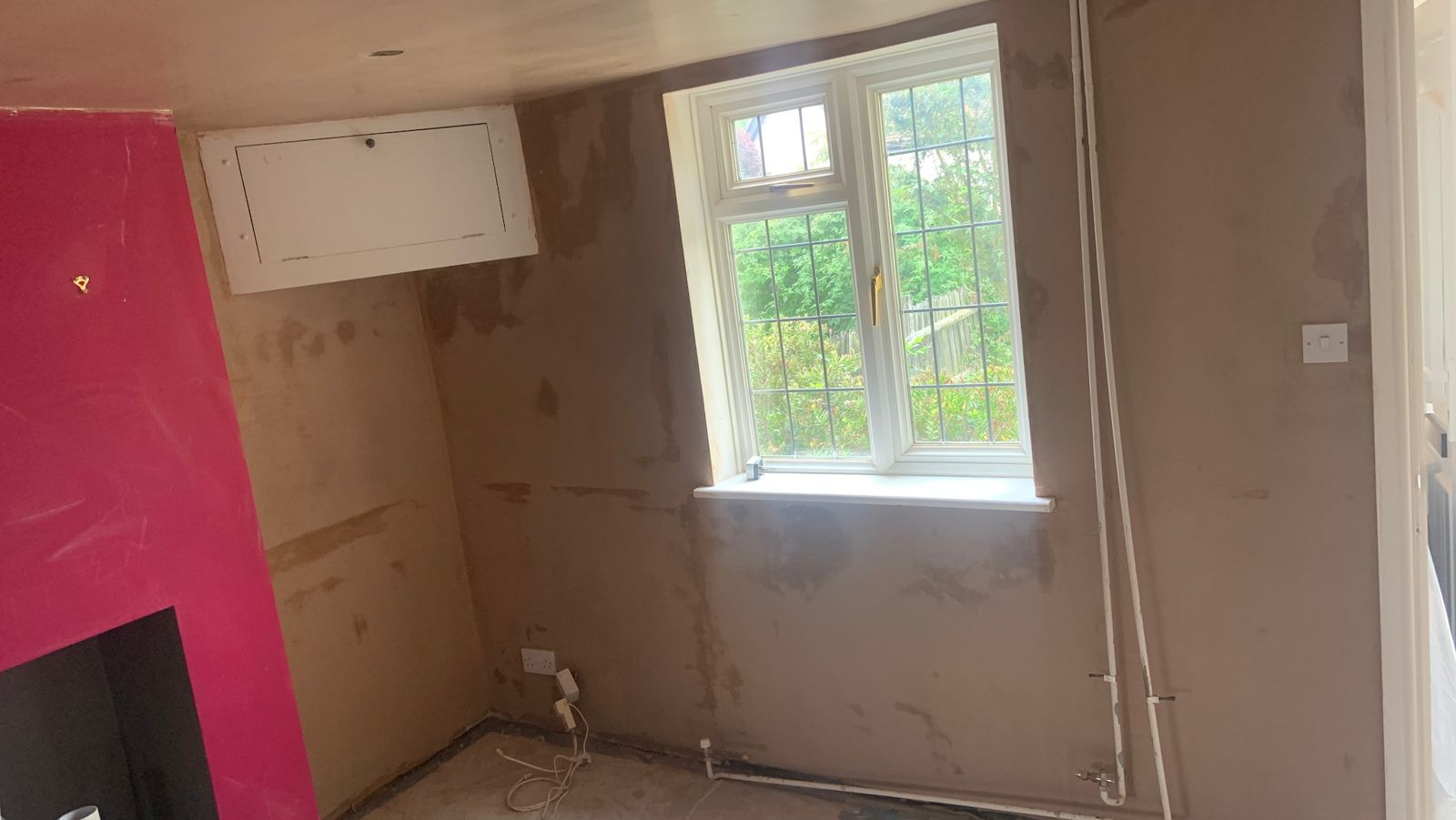 A room stripped back to fresh plaster, ready for the next stage