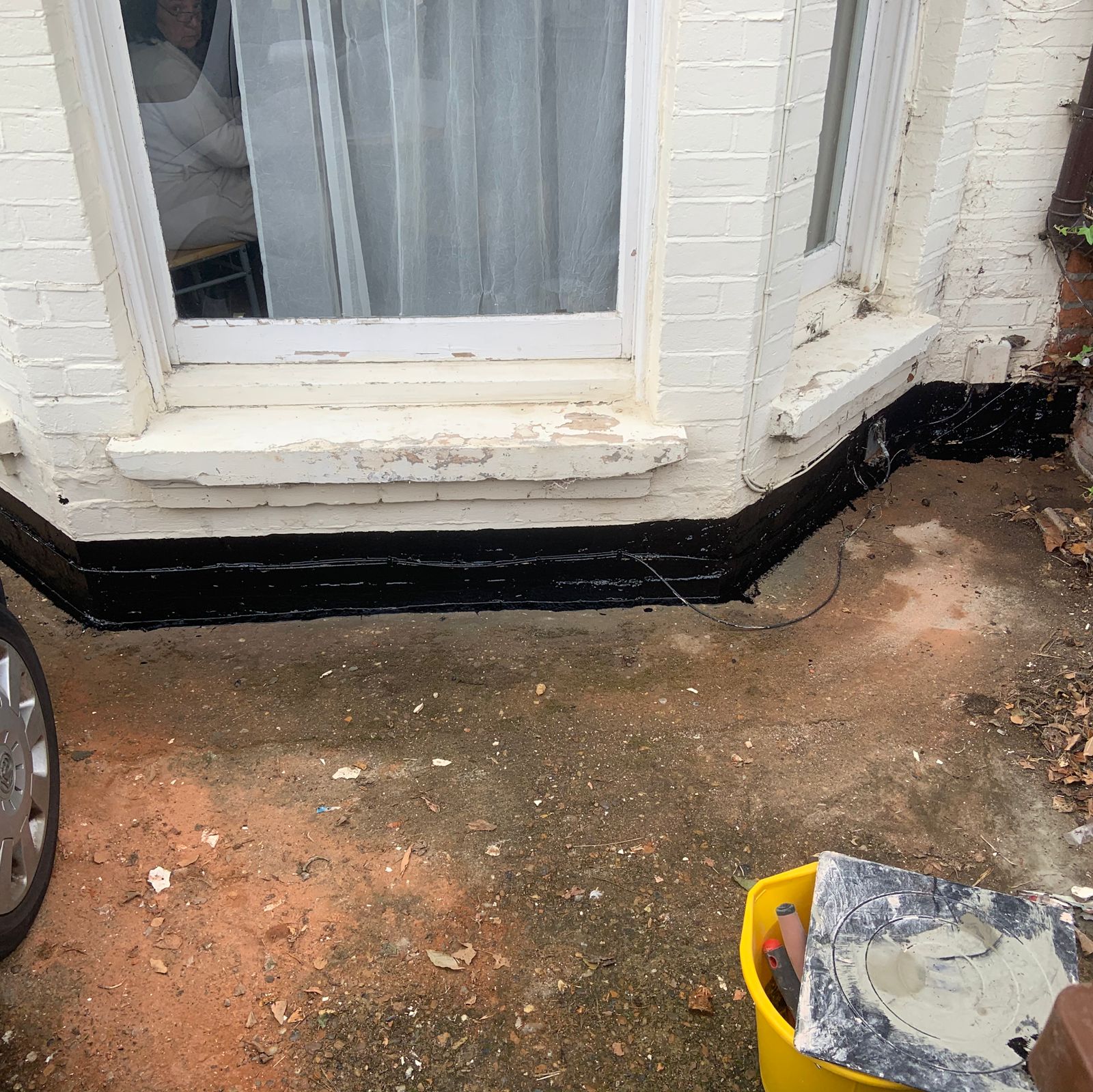 Waterproofing applied around the base of a painted bay